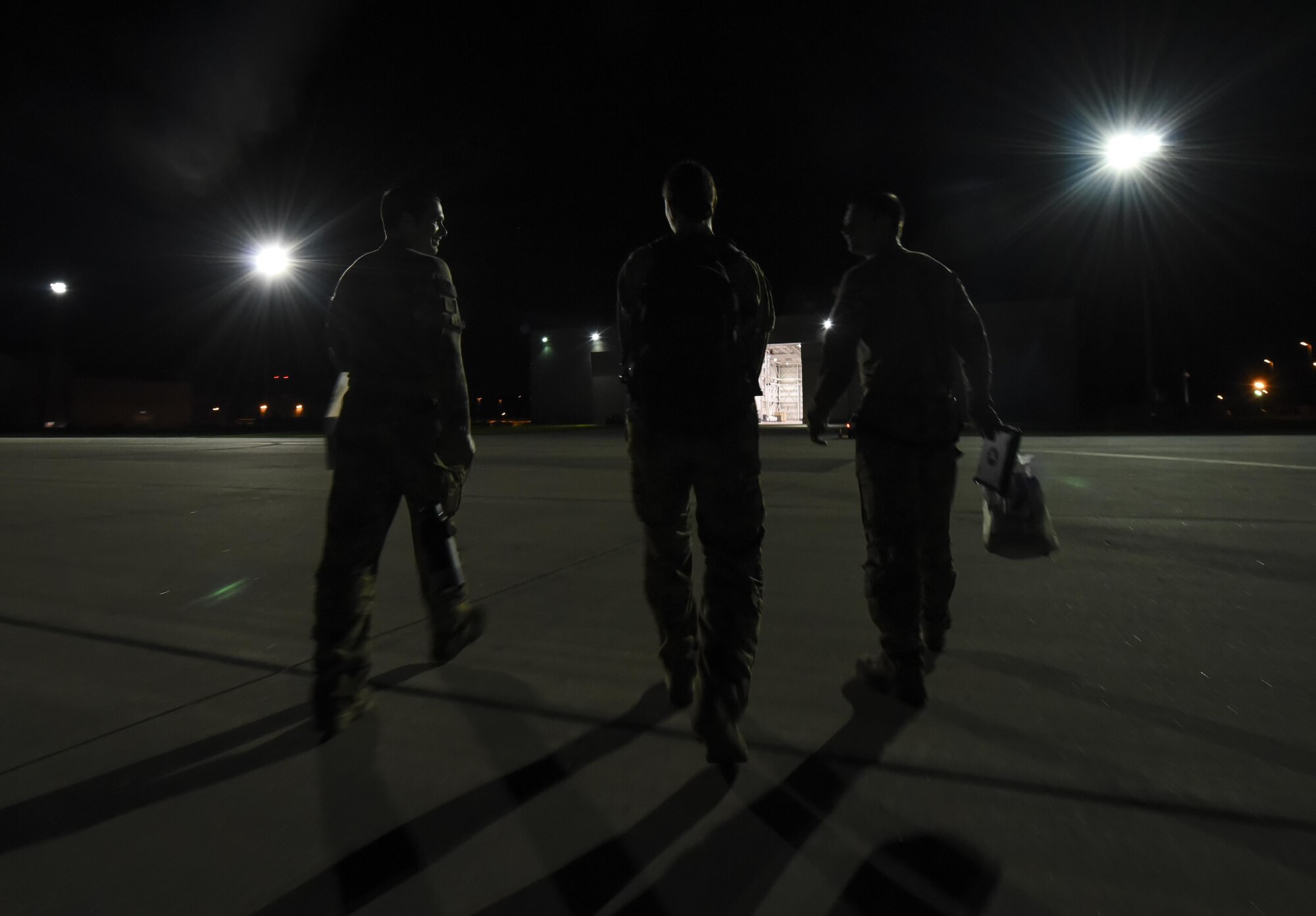 Air Commandos walk back towards a hangar after flying during Task Force Exercise Olympus Archer at Wright Patterson Air Force Base, Ohio, Aug. 21, 2016.  Olympus Archers focus is to maximize training opportunities for more than 230 Air Commandos with the 1st Special Operations Wing with an emphasis on medical operations in conjunction with flying operations. (U.S. Air Force photo by Staff Sgt. Christopher Callaway)