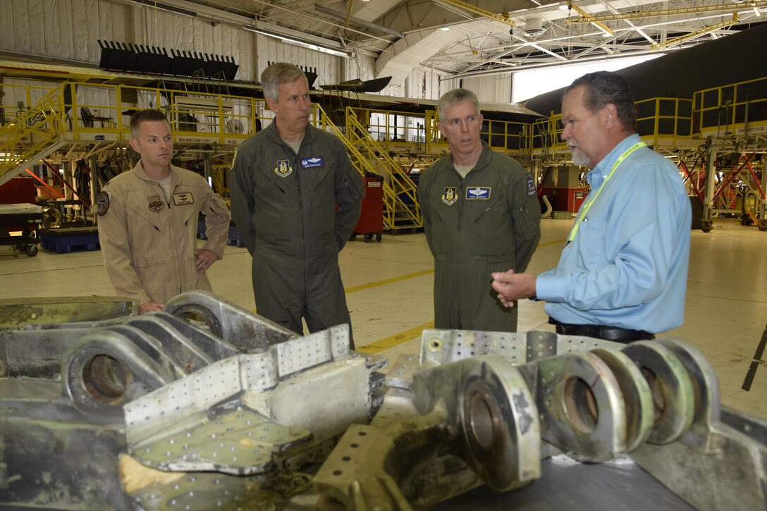 Mr. Charles Alley, right, 565th Maintenance Squadron director, briefs members of the 307th Bomb Wing on the depot level maintenance process and associated challenges with parts visible in the foreground, inside hangar 2121, Aug. 17, 2016, Tinker Air Force Base, Okla. Receiving the briefing are Maj. Aaron Bohl, 343rd Bomb Squadron, B-52 pilot, far left, Col. Rob Burgess, 307th Operations Group commander, second from left, and  Col. Trey Morriss, 307th BW vice commander. (U.S. Air Force photo/Greg L. Davis)