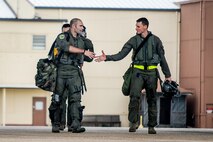 Colombian and U.S. Air Force pilots shake hands prior to boarding an A-29B Super Tucano during Exerccise Green Flag East at Barksdale Air Force Base, La., Aug. 17, 2016. Colombia and the U.S. share a special relationship, and the joint training exercise provided a platform to strengthen those ties. (U.S. Air Force photo / Senior Airman Mozer O. Da Cunha)
