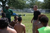 Staff Sgt. Michael T. Huck, a recruiter for Recruiting Sub Station West Omaha, mentors the North High School Polar Bears football team on the Marine Corps core values of honor, courage and commitment at the Football Leadership Camp at Grubb Stadium, Aug. 18. (U.S. Marine Corps photo by Cpl. Jennifer Webster/Released)
