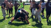 Staff Sgt. Kaleb V. Wagy (pictured right), the Recruiting Sub Station West Omaha staff non-commissioned officer in charge, and Sgt. Joseph E. Fralix (pictured left), a recruiter for Recruiting Sub Station Des Moines, alongside the Polar Bears football team motivate players to the end of an exercise during the Football Leadership Camp at Grubb Stadium, Aug. 18. (U.S. Marine Corps photo by Cpl. Jennifer Webster/ Released)
