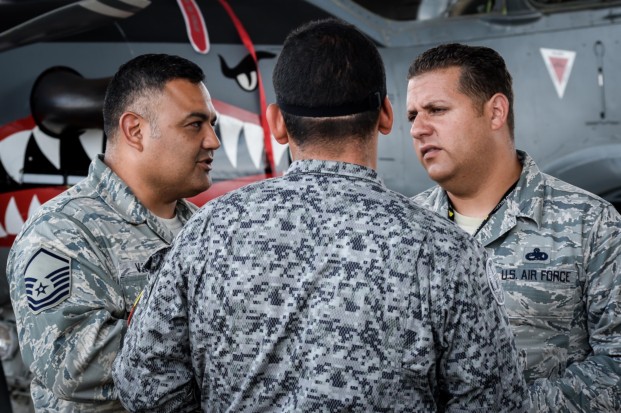 Master Sgt. Robert Vasquez (Left) and Master Sgt. Melvin Rosario (right) , both from 12th Air Force (Air Forces Southern) at Davis-Monthan Air Force Base, Ariz., speak with a Colombian aircraft maintainer during Exercise Green Flag East at Barksdale AFB, La., Aug 22, 2016. Bi-lingual U.S. Air Force maintenance Airmen worked together with their Colombian counterparts breaking the language barrier during the exercise. (U.S. Air Force photo / Senior Airman Mozer O. Da Cunha)