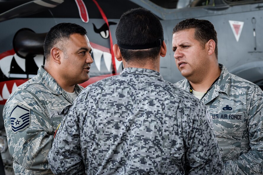 Master Sgt. Robert Vasquez (Left) and Master Sgt. Melvin Rosario (right) , both from 12th Air Force (Air Forces Southern) at Davis-Monthan Air Force Base, Ariz., speak with a Colombian aircraft maintainer during Exercise Green Flag East at Barksdale AFB, La., Aug 22, 2016. Bi-lingual U.S. Air Force maintenance Airmen worked together with their Colombian counterparts breaking the language barrier during the exercise. (U.S. Air Force photo / Senior Airman Mozer O. Da Cunha)
