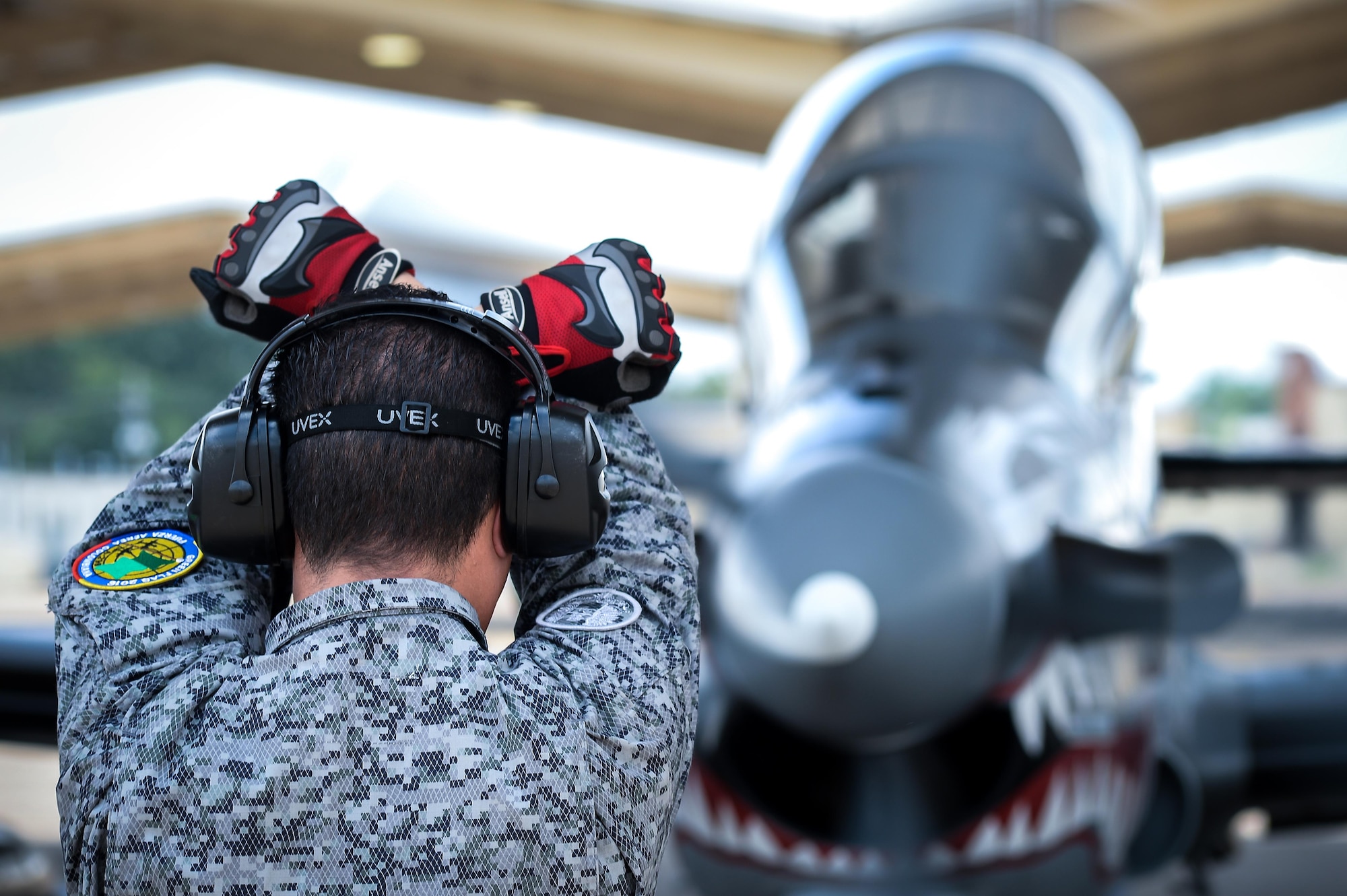 Colombian Air Force Technician 3rd Class Yessid Rubio a maintainer with the Colombian Air Force, marshalls an A-29B Super Tucano during Exercise Green Flag East at Barksdale Air Force Base, La., Aug 22, 2016.  Bi-Lingual American maintenance Airmen worked with Colombian counterparts assisting them with local equipment and procedures. (U.S. Air Force photo / Senior Airman Mozer O. Da Cunha)
