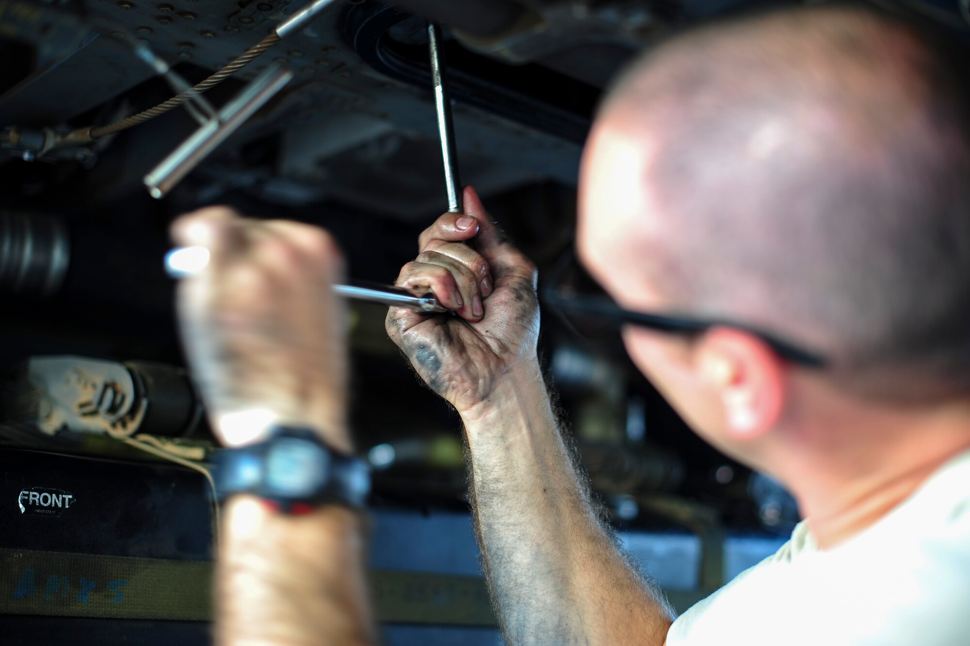 U.S. Air Force Staff Sgt. Gage, 923d Aircraft Maintenance Squadron crew chief, performs maintenance on an HH-60G Pave Hawk at Davis-Monthan Air Force Base, Ariz., Aug. 23, 2016. The 923d AMXS plans and directs scheduled and unscheduled maintenance to ensure mission-ready status. (U.S. Air Force photo by Airman Nathan H. Barbour)