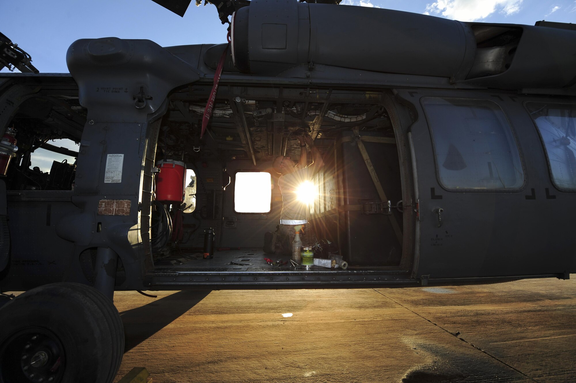 U.S. Air Force Staff Sgt. Gage, 923d Aircraft Maintenance Squadron crew chief, performs maintenance on an HH-60G Pave Hawk at Davis-Monthan Air Force Base, Ariz., Aug. 23, 2016. The 923d AMXS maintains, services and inspects HC-130J and HH-60 aircraft. (U.S. Air Force photo by Airman Nathan H. Barbour)