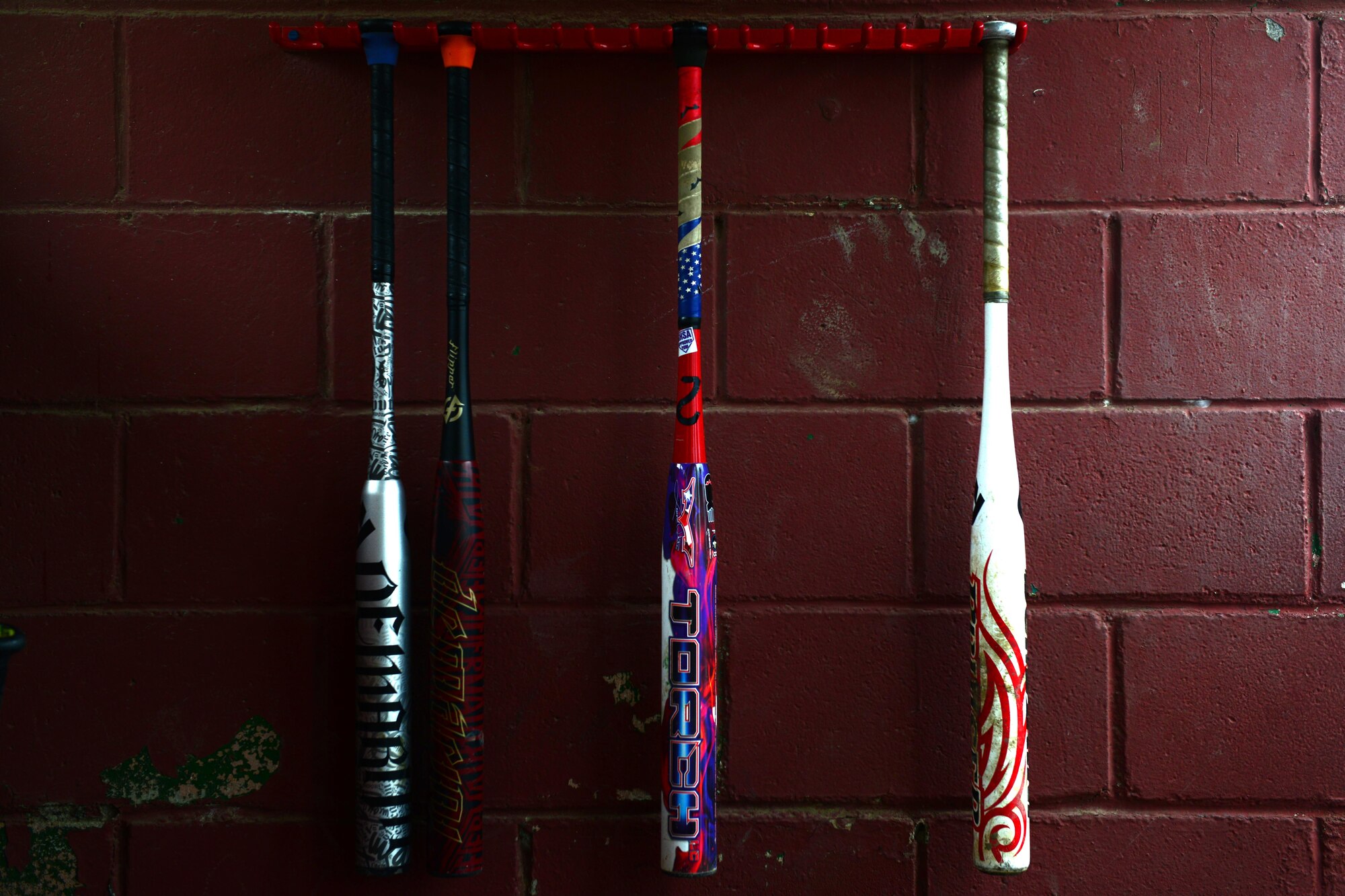 Bats hang in the 703d Aircraft Maintenance Squadron dugout at the baseball field near Buckner Physical Fitness Center at Joint Base Elmendorf-Richardson, Alaska, during the intramural softball playoffs Aug. 17, 2016. The Arctic Medics with the 673d Medical Group were undefeated in the 2016 season. (U.S. Air Force photo by Airman 1st Class Javier Alvarez)