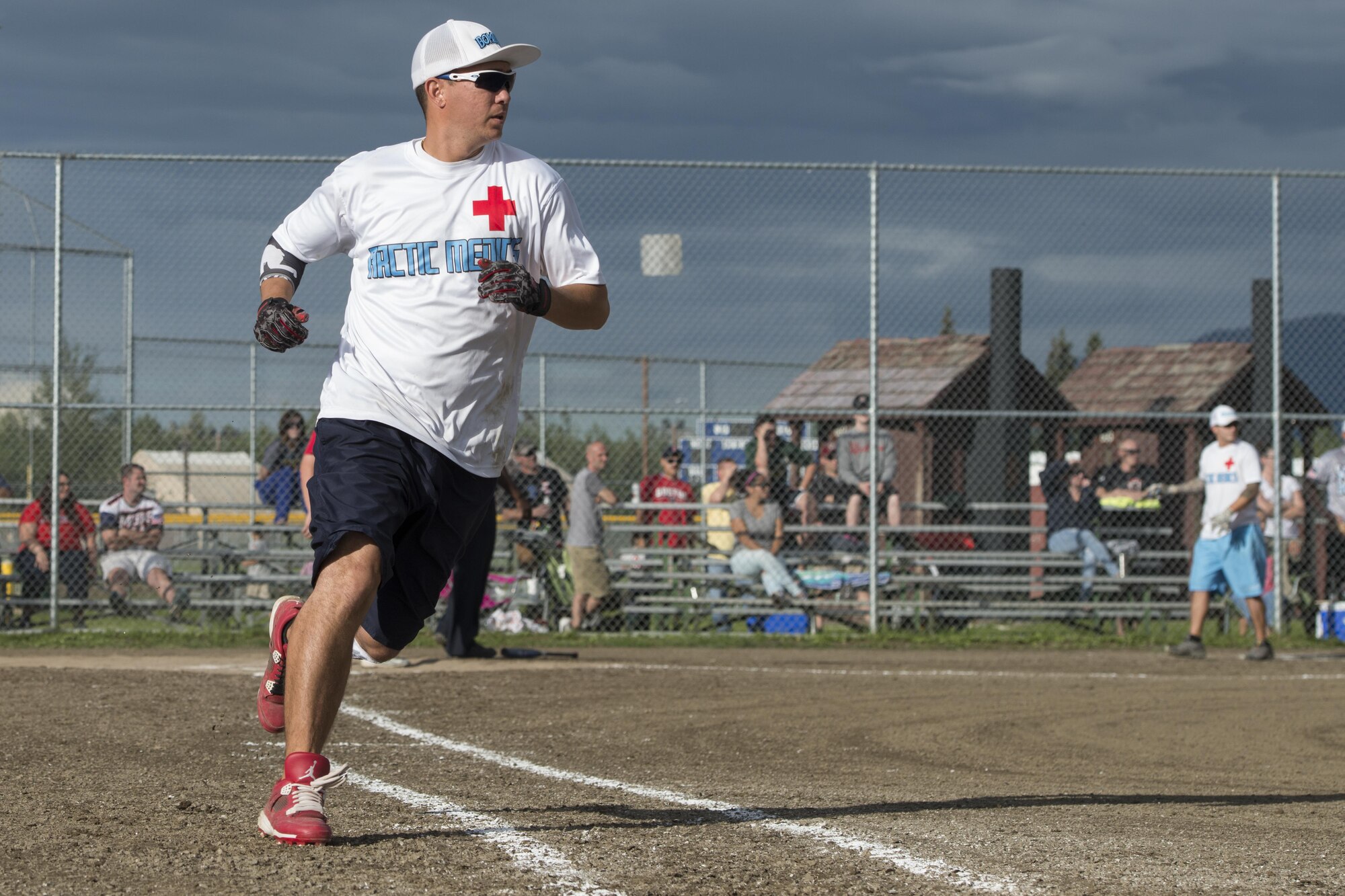Terry Shoup rounds first base at the baseball field near Buckner Physical Fitness Center at Joint Base Elmendorf-Richardson, Alaska, during the intramural softball playoffs, Aug. 18, 2016. Thirty-eight teams participated in the intramural softball 2016 season. Each team played 18 games in the regular season. Eight teams with the best record made it to the playoffs. (U.S. Air Force photo by Airman 1st Class Javier Alvarez)