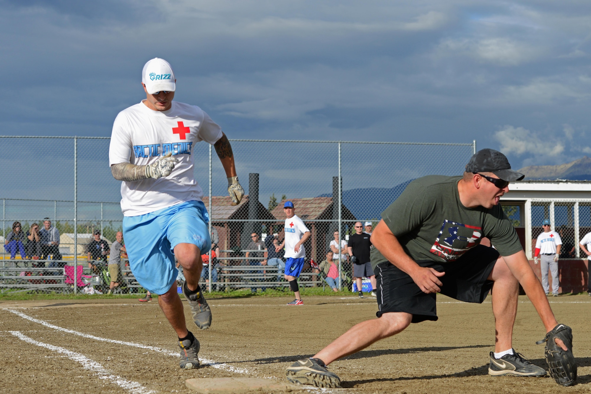 Andrew Taylor races to first base during the intramural softball playoffs at the baseball field behind Buckner Physical Fitness Center, at Joint Base Elmendorf-Richardson, Alaska, Aug. 18, 2016. The Arctic Medics with the 673d Medical Group beat the 703d Aircraft Maintenance Squadron team for the championship. (U.S. Air Force photo by Airman 1st Class Javier Alvarez)