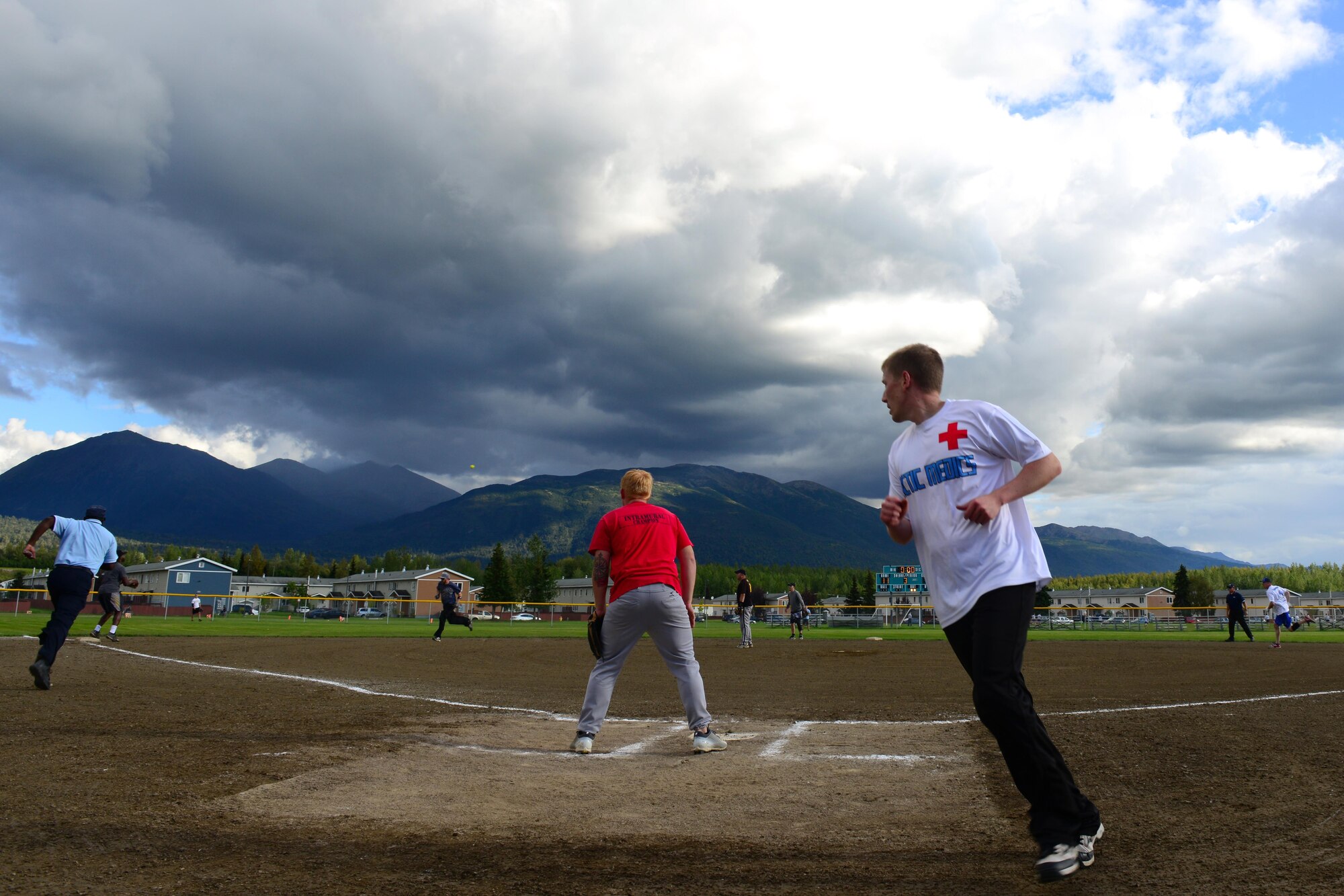 Robert McMillian, an Amateur Softball Association certified head referee, races to third base as Arctic Medics round the bases at the baseball field behind Buckner Physical Fitness Center, at Joint Base Elmendorf-Richardson, Alaska, Aug. 18, 2016. The Arctic Medics with the 673d Medical Group beat the 703d Aircraft Maintenance Squadron team for the championship. (U.S. Air Force photo by Airman 1st Class Javier Alvarez)
