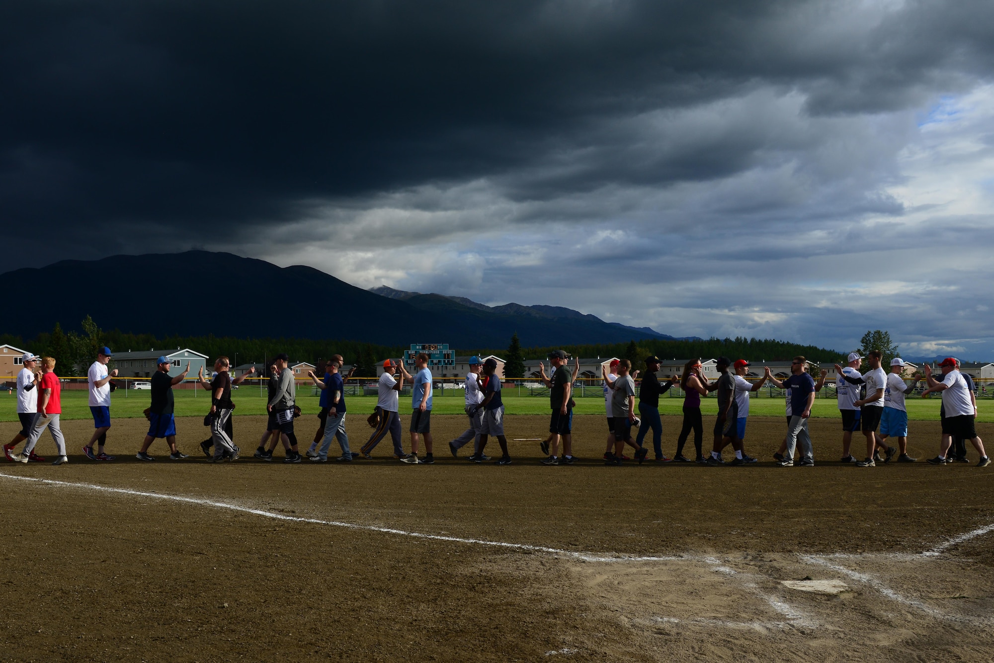 Teams shake hands after the final softball game of the 2016 season at the baseball field behind Buckner Physical Fitness Center, at Joint Base Elmendorf-Richardson, Alaska, Aug. 18, 2016. The Arctic Medics with the 673d Medical Group beat the 703d Aircraft Maintenance Squadron team for the championship. (U.S. Air Force photo by Airman 1st Class Javier Alvarez)