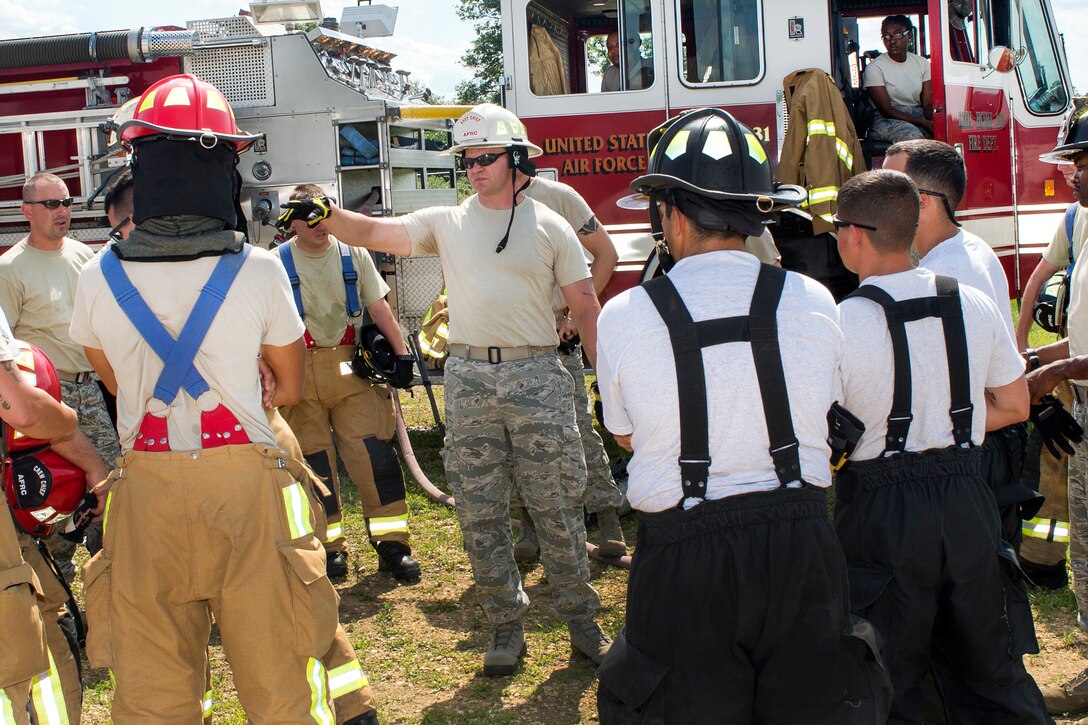 Air Force Tech. Sgt. Devon Parsons, center, gives a safety briefing to Air Force Reserve firefighters before performing a fuel burn during Exercise Patriot Warrior 2016 at the airport at Fort McCoy, Wis., Aug. 18, 2016. Parsons is an assistant chief of operations assigned to the 910th Civil Engineer Squadron. Air Force photo by Tech. Sgt. Nathan Rivard