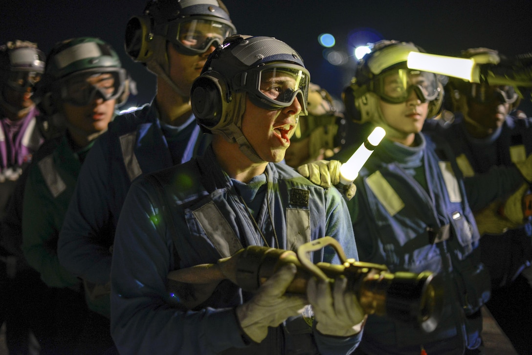 Sailors participate in nighttime firefighting drills on the flight deck of the aircraft carrier USS Nimitz at Naval Base Kitsap-Bremerton, Wash., Aug. 23, 2016. The Nimitz is undergoing extended incremental maintenance. Navy photo by Seaman Recruit Cody M. Deccio
