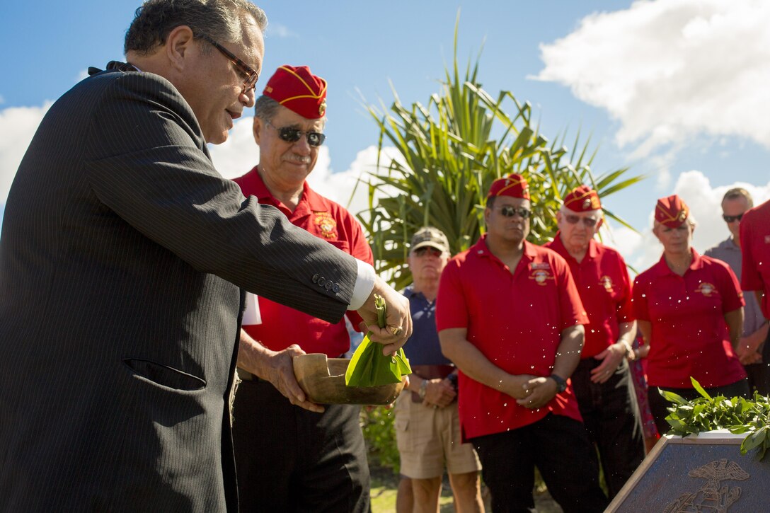 Minister Kahu Kelekona Bishaw performs a traditional Hawaiian blessing during the Marine Memorial Rededication Ceremony at the USS ARIZONA Education Center, Honolulu, Hawaii, Aug. 19, 2016. Bishaw sprinkled fresh Hawaiian water over the memorial, representing the connection between Hawaii and the fallen Marines. 