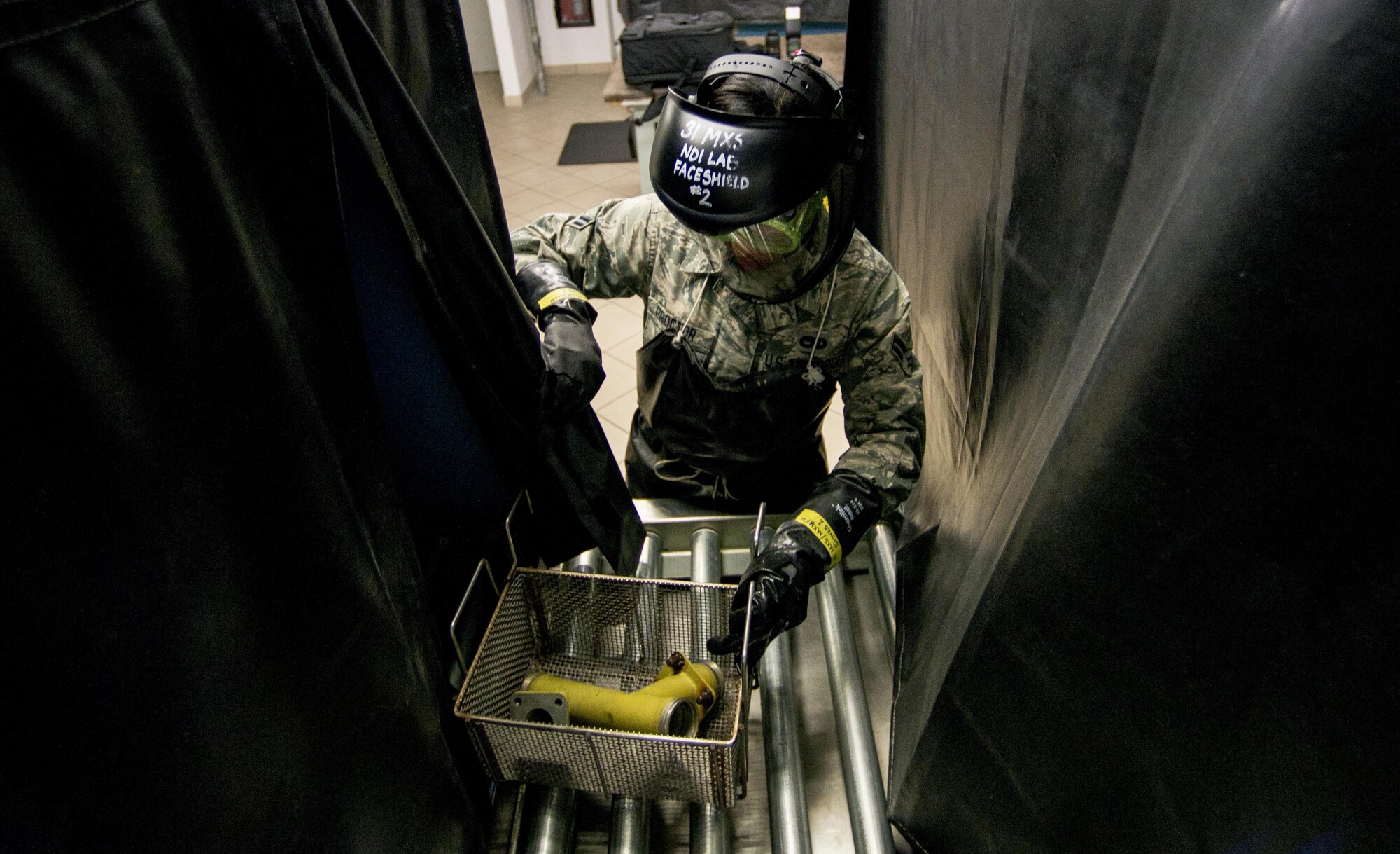 Airman 1st Class Victoria Proctor, 31 Maintenance Squadron non-destructive inspection apprentice, processes a defective piece of equipment through a non-destructive inspection line, Aug. 23, 2016, at Aviano Air Base, Italy. Non-destructive inspection Airmen are responsible for conducting preventative maintenance inspections on equipment and aircraft assigned to the 31st Fighter Wing. (U.S. Air Force photo by Airman 1st Class Cory W. Bush/Released)