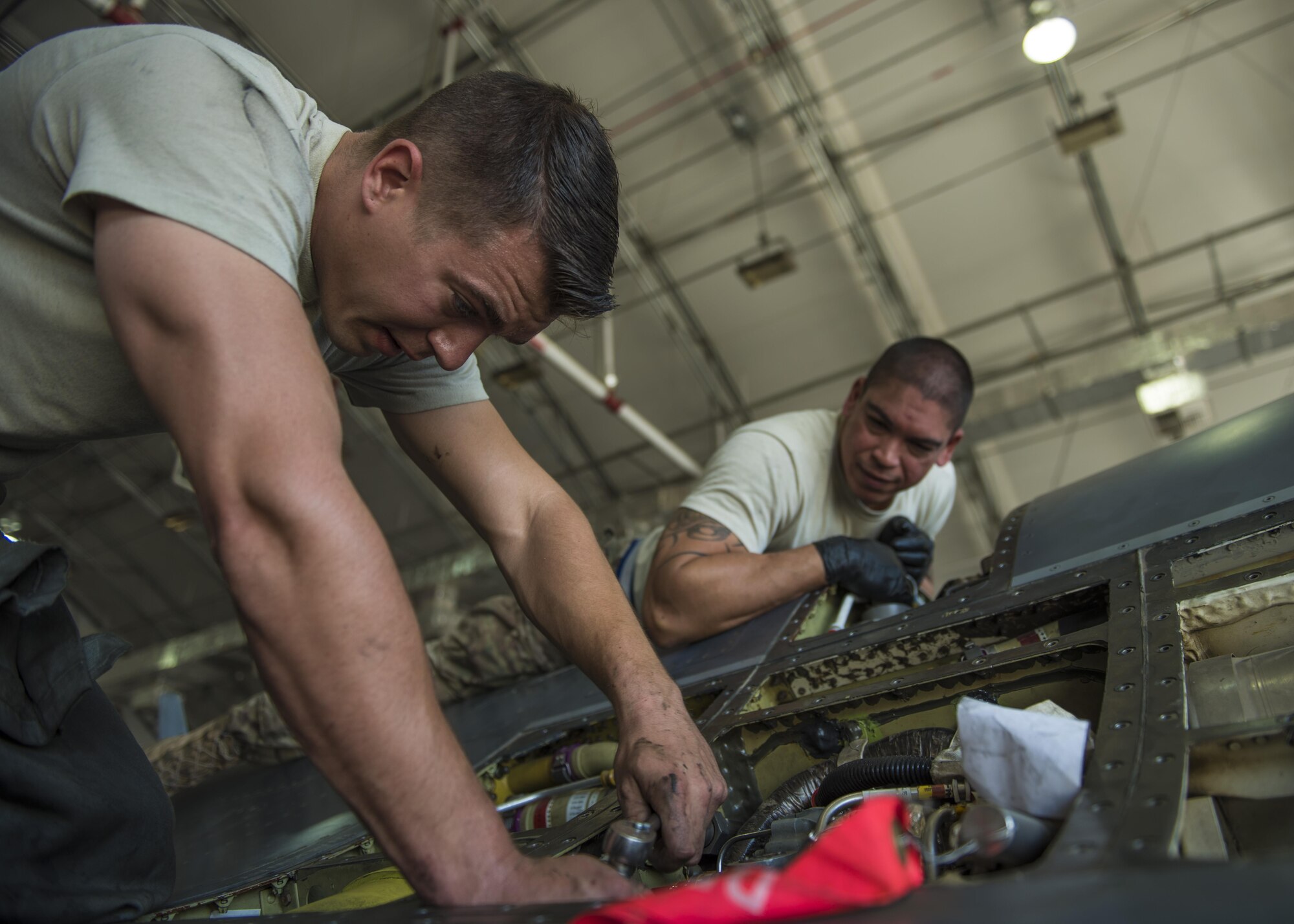 Senior Airman Michael Nemec, 455th Expeditionary Maintenance Squadron crew chief, installs an angle gear box on an F-16C Fighting Falcon, Bagram Airfield, Afghanistan, Aug. 22, 2016. The gear box transfers power to the leading edge flap torque shaft to help the aircraft achieve lift during takeoff. (U.S. Air Force photo by Senior Airman Justyn M. Freeman)