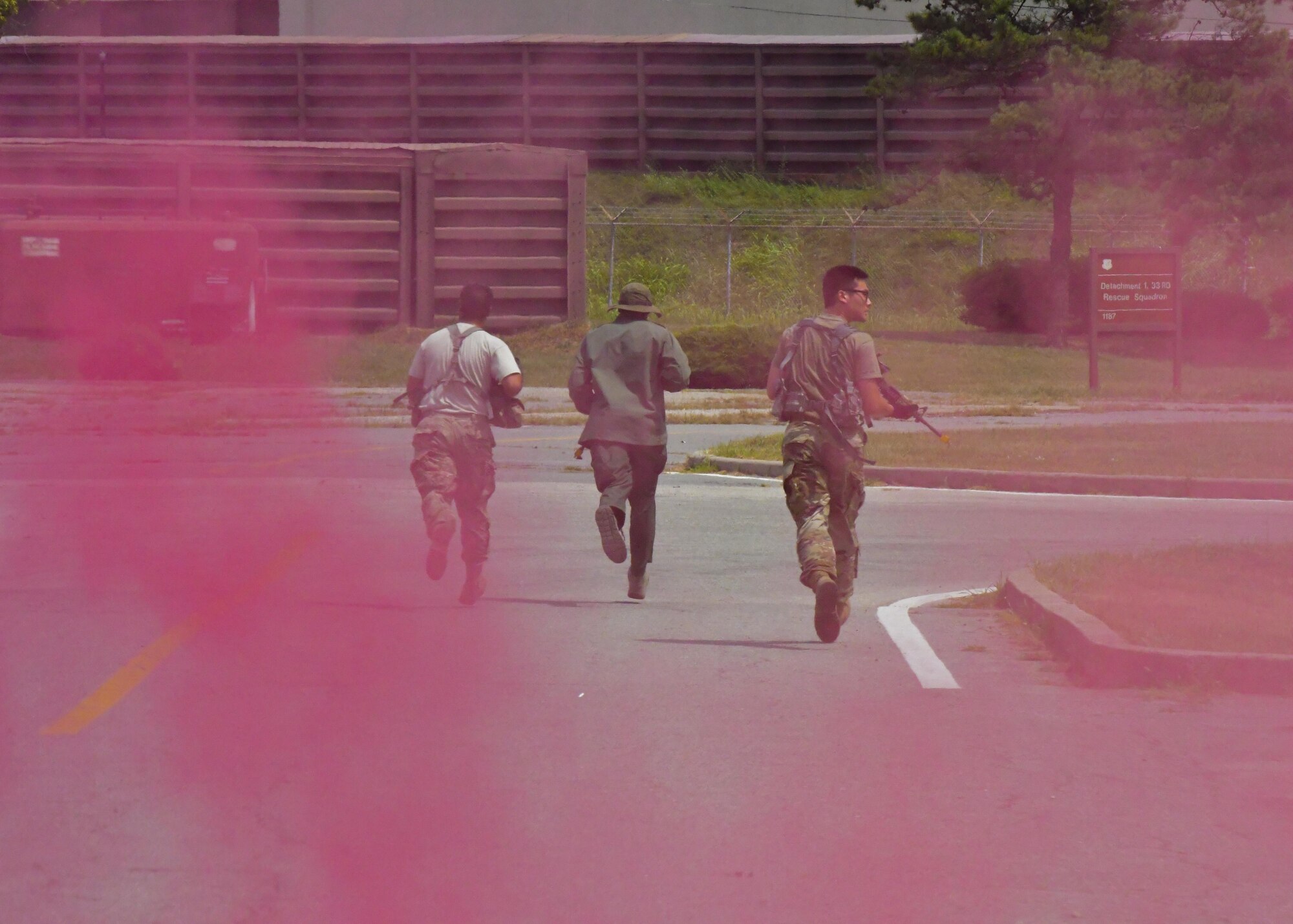 Team Osan opposition forces move to a different position during a simulated attack during Exercise Beverly Herd 16-2 at Osan Air Base, Republic of Korea, Aug. 25, 2016. Personnel from the 51st Security Forces Squadron had to respond to reports of the attack, quickly incapacitating the simulated attackers. (U.S. Air Force photo by Senior Airman Victor J. Caputo)