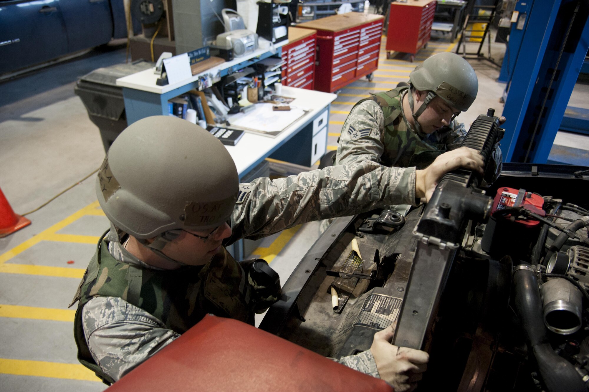 Senior Airman Thomas Harvey and Senior Airman Dillon Goulet, 51st Logistics Readiness Squadron mission generating and vehicle maintenance journeymen, remove a leaking radiator from a vehicle during Exercise Beverly Herd 16-2 on Osan Air Base, Republic of Korea, Aug. 25, 2016. Harvey and Goulet continue to enable base operations and defense of the base by fixing vehicles so they can be returned to the field. (U.S. Air Force photo by Staff Sgt. Jonathan Steffen)  