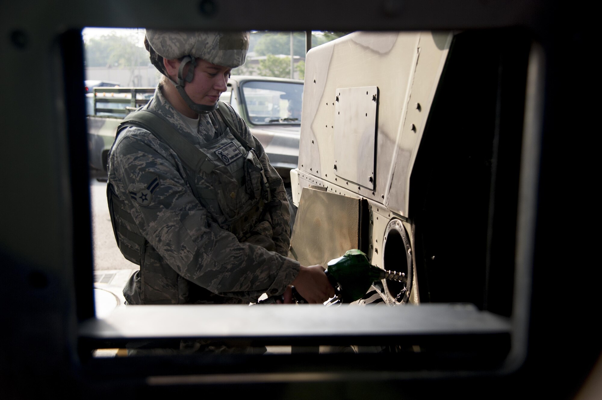Senior Airman Samantha Erasmus, 51st Security Force Squadron heavy gunner, refuels a Humvee during Exercise Beverly Herd 16-2 on Osan Air Base, Republic of Korea, Aug. 26, 2016. Erasmus and other security forces Airmen defend the base by actively patrolling for opposition forces during the exercise. (U.S. Air Force photo by Staff Sgt. Jonathan Steffen) 