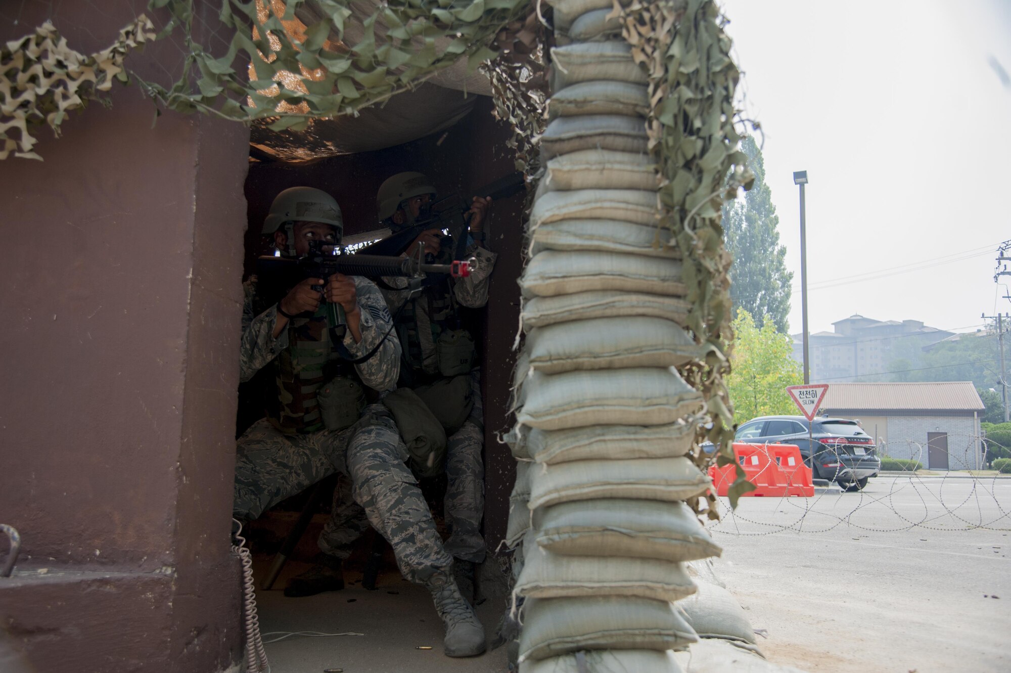 Staff Sgt. Michael Campbell, 51st Communications Squadron client systems technician, shoots back from a defensive fighting position during a mock attack from opposing forces at Osan Air Base, Republic of Korea, Aug. 25, 2016. The mock attack was a scenario during exercise Beverly Herd 16-2 designed to test Osan’s Airmen to test their ability to survive and operate during contingency operations. (U.S. Air Force photo by Staff Sgt. Jonathan Steffen)