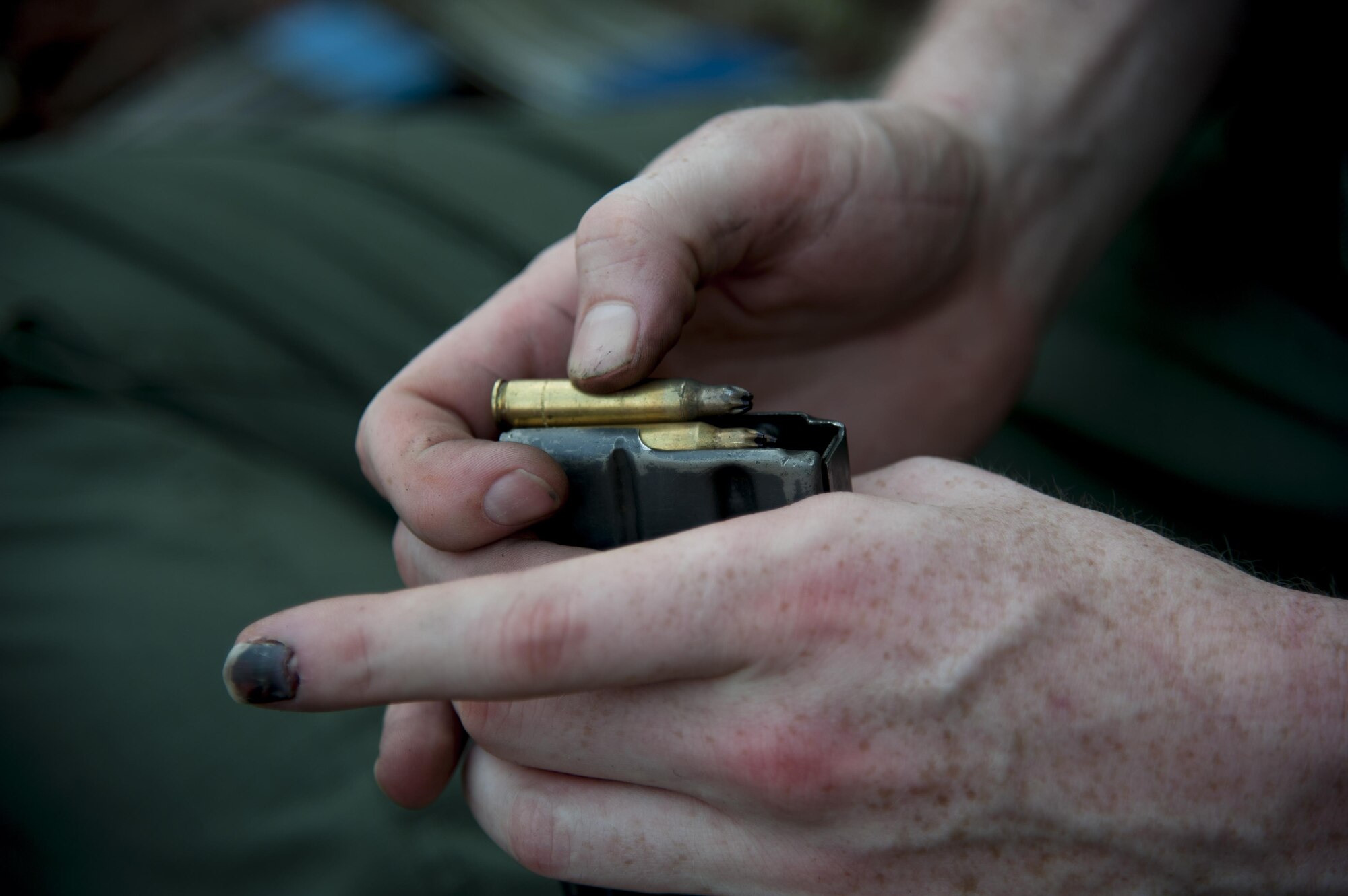 An opposing forces member reloads his blank ammunition before continuing a mock attack on the 51st Communications Squadron during Exercise Beverly Herd 16-2 on Osan Air Base, Republic of Korea, Aug. 26, 2016. The mock attack allowed the 51st CS to be assessed on their ability to defend the base. (U.S. Air Force photo by Staff Sgt. Jonathan Steffen)