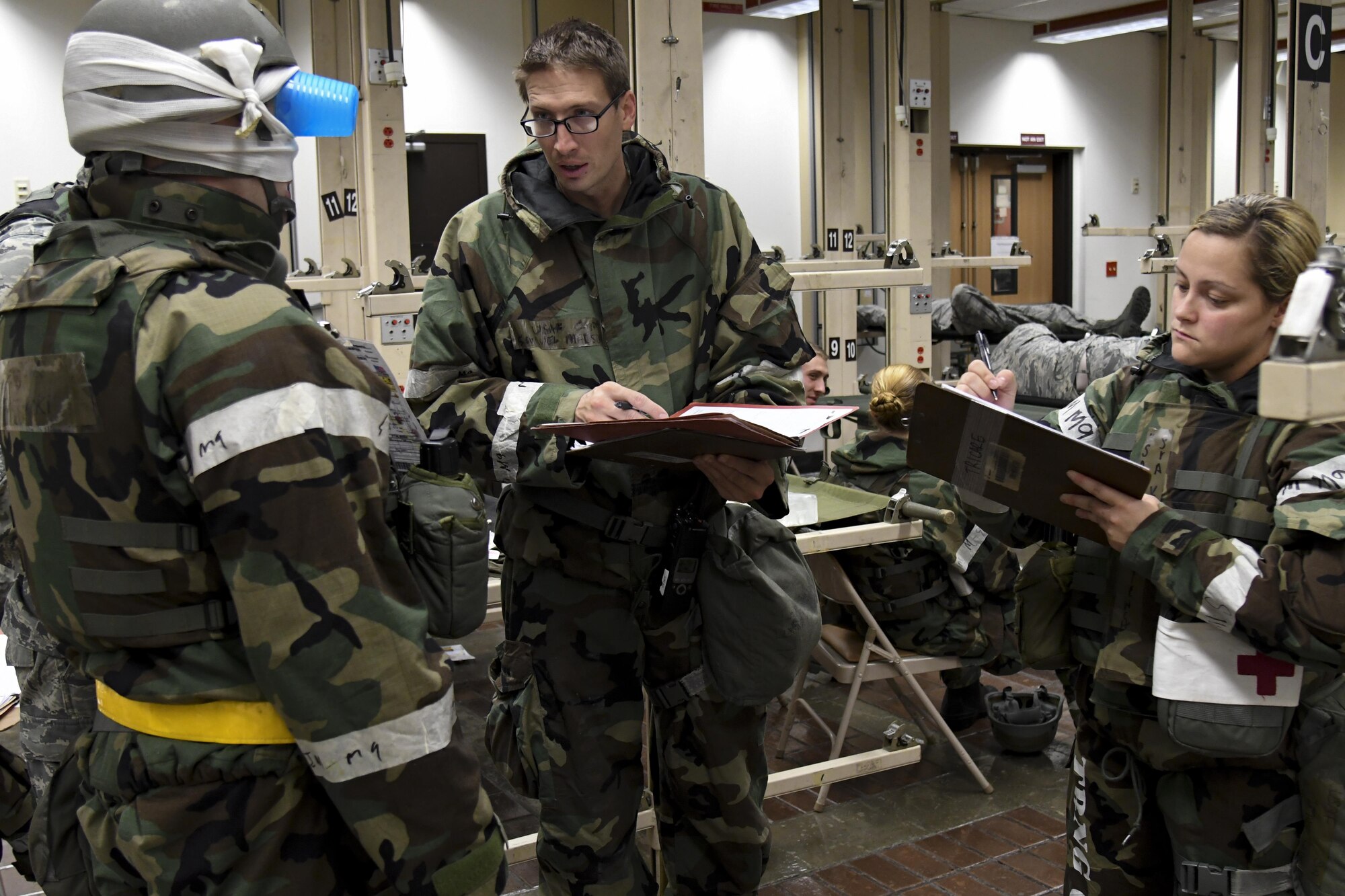 Capt. Samuel Madson, 51st Medical Operations Squadron delayed team chief, and Senior Airman Kaitlyn Tench, 51st Medical Support Squadron aeromedical clerk, gathers medical information about a mock patient with a head injury during Exercise Beverly Herd 16-2. The information gathered will be used to keep track of the patient while in holding for an aeromedical evacuation. (U.S. Air Force photo by Staff Sgt. Jonathan Steffen)