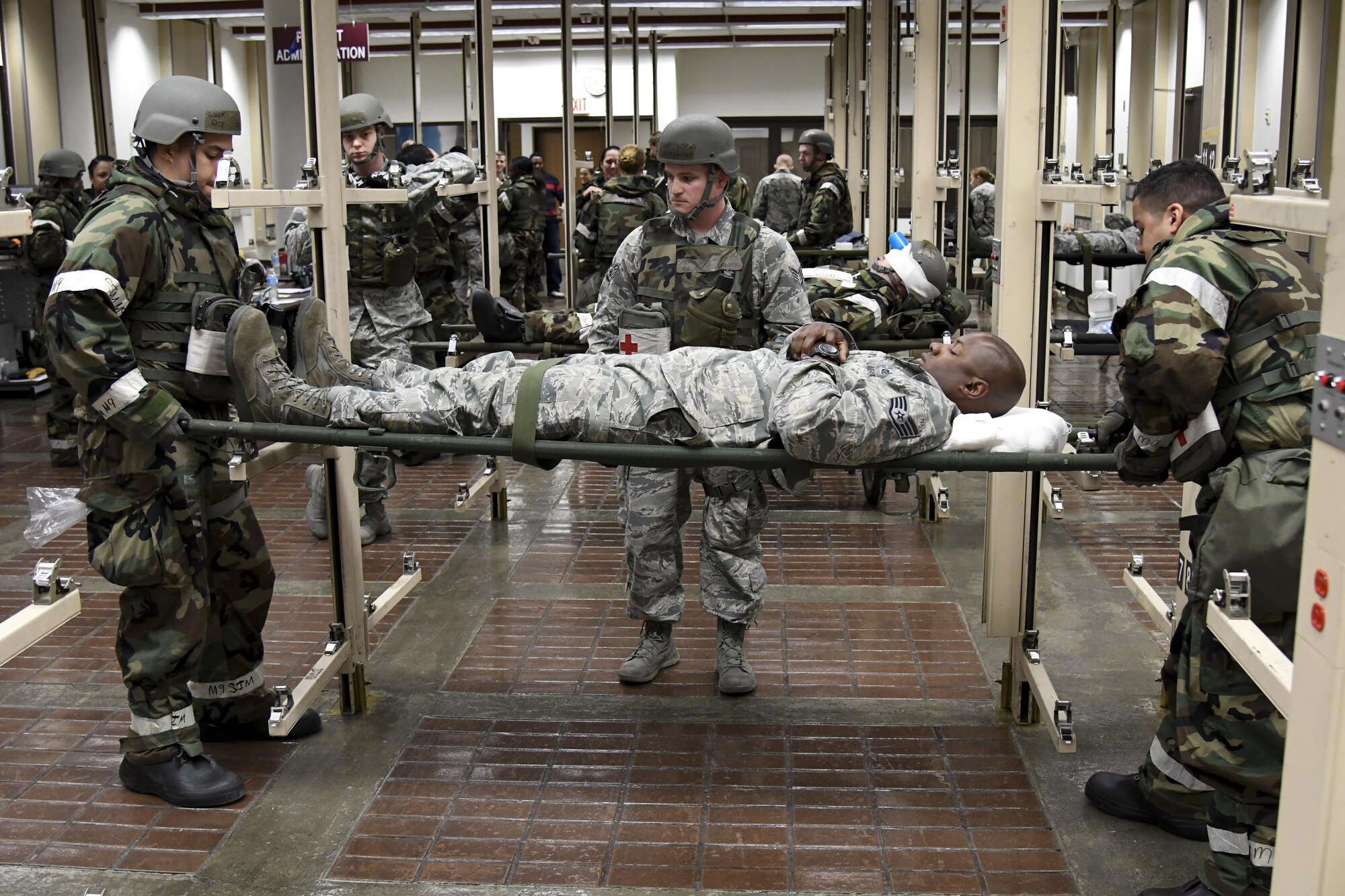 Medics from the 51st Medical Group transport mock patients to a stretcher prior to aeromedical evacuation during Exercise Beverly Herd 16-2 on Osan Air Base, Republic of Korea, Aug. 24, 2016. The aeromedical evacuation scenario allowed the medics to hone their skills on safety transport patients to aircraft. (U.S. Air Force photo by Staff Sgt. Jonathan Steffen)