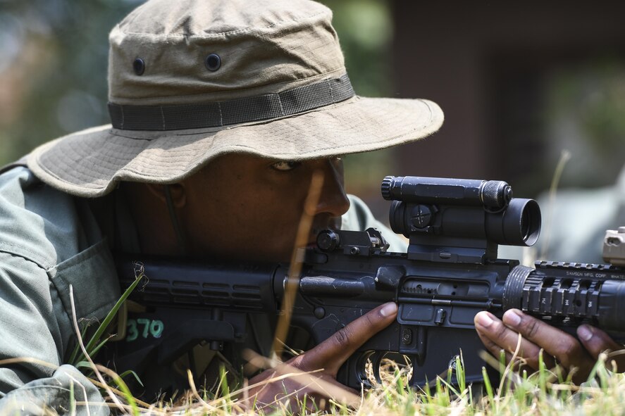 Simulated opposing forces member Airman 1st Class Jared Small stares down his sights while waiting for a truck with munitions to roll by during Exercise Beverly Herd 16-2, on Osan Air Base, Republic of Korea, Aug. 24, 2016. The OPFOR scenario was set up for U.S. armed forces to practice combat techniques. Beverly Herd provides U.S. armed for the opportunity to hone combat skills that can be used in the event of real-world contingencies. (U.S. Air Force photo by Tech. Sgt. Rasheen Douglas) 