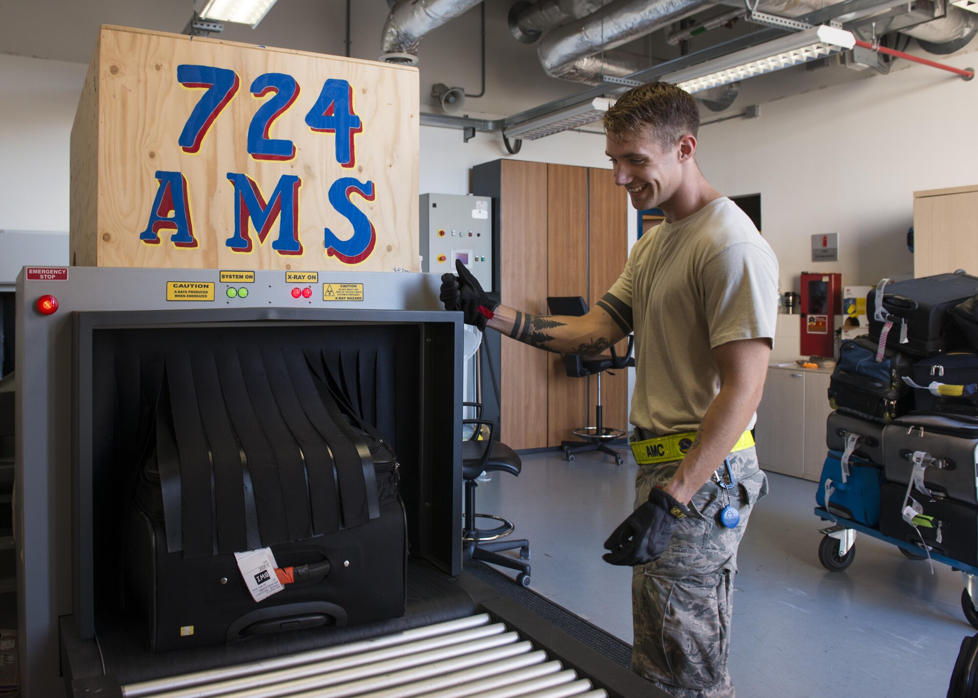 Airman 1st Class Kalvin Langford, 724th Air Mobility Squadron passenger service agent, scans luggage prior to loading it onto a plane Aug. 24, 2016, at Aviano Air Base, Italy. The 724th AMS passenger terminal offers a variety of travel options for military members including the Air Mobility Command’s Patriot Express and space-available flights on military aircraft.  (U.S. Air Force photo by Senior Airman Krystal Ardrey/Released)