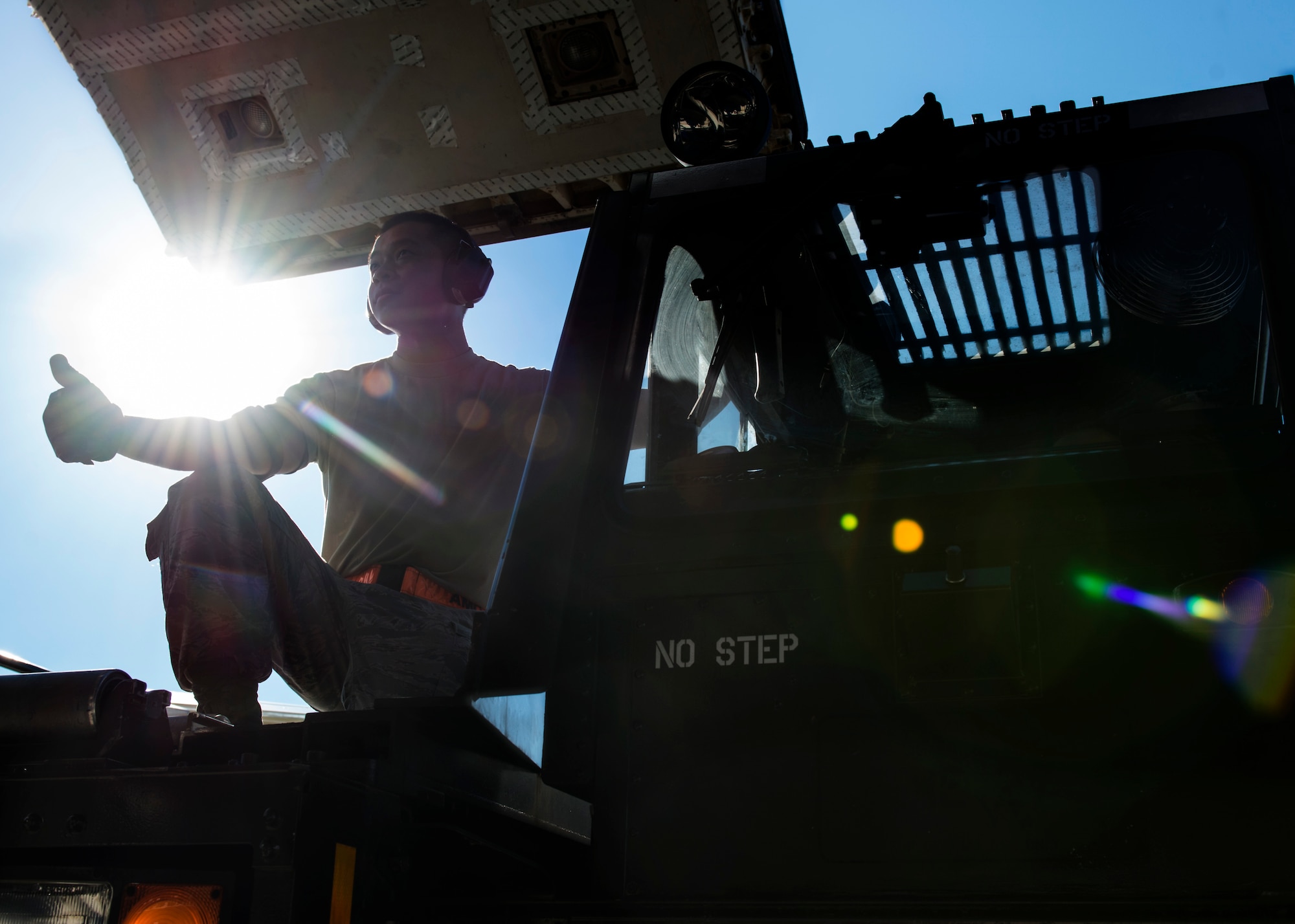 Staff Sgt. Raymond Zhen, 724th Air Mobility Squadron aircraft services supervisor, guides the positioning of a 60K Tunner Aug. 24, 2016, at Aviano Air Base, Italy. The 724th Air Mobility Squadron has facilitated the transportation of 15,841 individuals and 292 tons of cargo so far this year. (U.S. Air Force photo by Senior Airman Krystal Ardrey/Released)