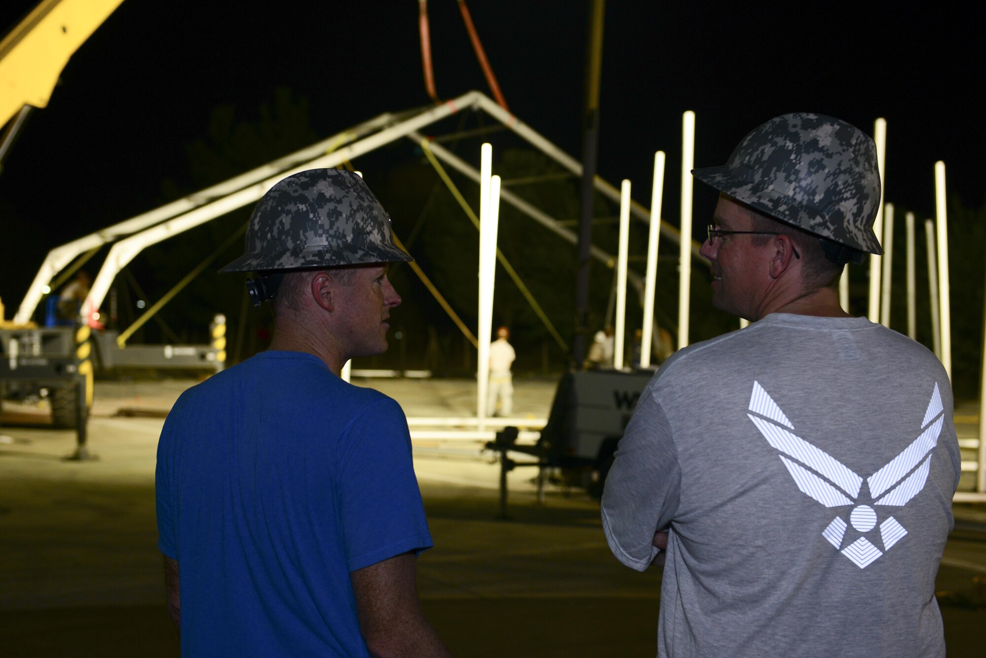 U.S. Air Force Col. Todd Stratton, 39th Mission Support Group commander, left, speaks with Maj. Myles Gilbert, 39th Civil Engineer Squadron commander, Aug. 7, 2016, at Incirlik Air Base, Turkey. The two spoke about an 8K dome shelter being built. (U.S. Air Force photo by Tech. Sgt. Caleb Pierce)