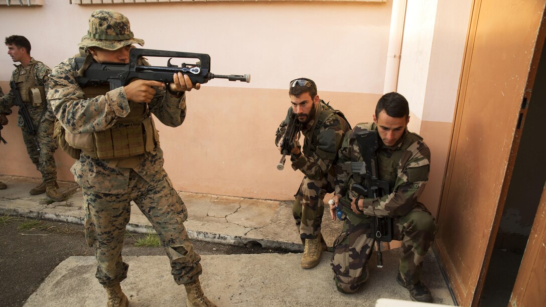 A Marine with Marine Rotational Force – Darwin and French Army soldiers with 92nd Infantry Regiment prepare to enter a building during a French Armed Forces Nautical Commando Course at Quartier Gribeauval, New Caledonia, August 17, 2016. The course is a part of Exercise AmeriCal 16, a bilateral training exercise designed to enhance mutual combat capabilities and improve relations with our partners by exchanging a U.S. Marine Corps and French Armed Forces infantry platoon. While the U.S. Marines are in New Caledonia, the French infantry platoon traveled to Australia to participate in Exercise Koolendong 16 with U.S. and Australian forces. 