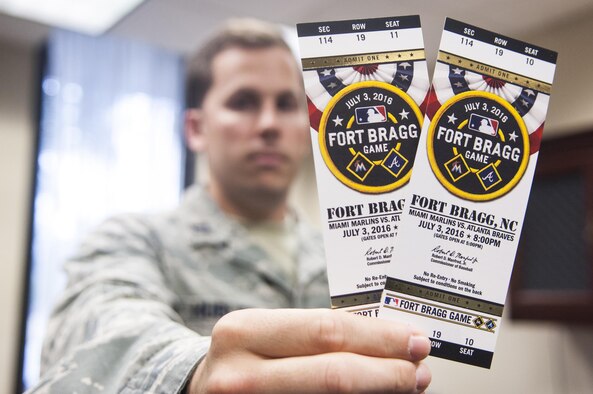 Capt. Tim Hubler, 43d Air Mobility Operations Group executive officer, proudly displays his tickets to the Atlanta Braves vs. Miami Marlins baseball game, to be played here July 3. He will join hundreds of Pope Airmen and thousands of Soldiers at the game -- the first MLB regular season game played on an active military installation.  (U.S. Air Force photo/Marc Barnes)