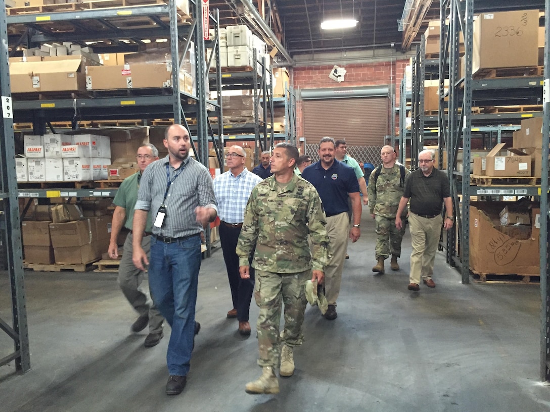 Chase Helm, ACI warehouse supervisor at DLA Distribution Jacksonville, Fla., explains wholesale operations and storage challenges at the distribution center to Army Brig. Gen. John Laskodi, DLA Distribution commander, on Aug. 8.  Also pictured are (left to right): Keith Burney, ACI program manager; Helm; Joe DeCristofaro, facilities specialist; John Pisarski, accountable officer; Laskodi; Charles Crumb, Jacksonville's deputy director; Brian Burkholder, Jacksonville's director; Jared Crain, DLA Distribution Current Operations branch chief; Army Capt. Brandon Thomas, Distribution's aide-de-camp; and Bob Vickers, quality assurance lead.  