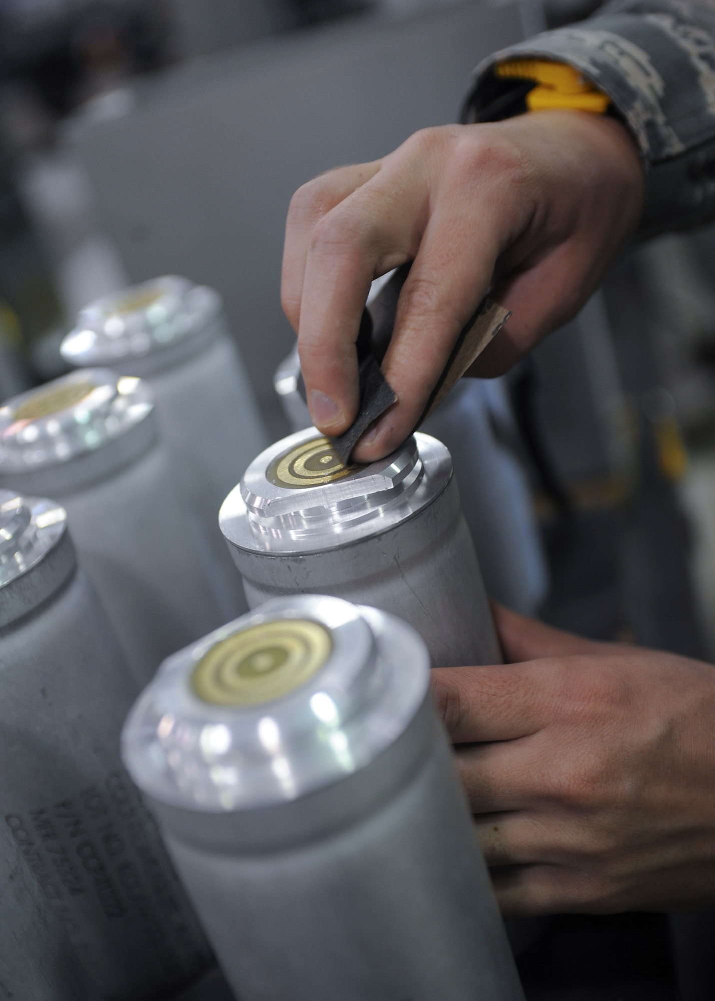 A 2nd Munitions Squadron Production Flight Airman cleans the contact points of a flare stick after the module failed a resistance test at Barksdale Air Force Base, La., August 18, 2016. When cleaning the stick, Airmen wear a grounding wrist strap to prevent setting off the flare. (U.S. Air Force photo/Airman 1st Class Stuart Bright)