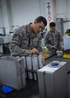 Staff Sgt. Nathan Burk, 2nd Munitions Squadron Production Flight conventional maintenance crew chief, cleans the contact points of flare sticks at Barksdale Air Force Base, La., August 18, 2016. A module holds the flares when it is bolted on the jet. (U.S. Air Force photo/Airman 1st Class Stuart Bright)
