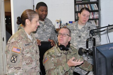 BUTLERVILLE, Ind. – Indiana National Guard Master Sgt. Bradley Staggs (sitting), of the 38th Infantry Division, shows U.S. Army Reserve Soldiers with the 206th Broadcast Operations Detachment and 205th Press Camp Headquarters how to run radio broadcast equipment during Exercise News Day at MUTC on Aug. 23, 2016. (U.S. Army Reserve photo by Maj. Elizabeth M. Griffith, 206th Broadcast Operations Detachment/Released)