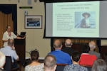 The Women's Equality Day event guest speaker, Kathryn Ray, former president of The League of Women Voters of the District of Columbia and currently a reference librarian at American University in Washington, D.C., speaks to Defense Logistics Agency employees about women's struggles and triumphs to gain the right to vote during a Women’s Equality Day event held at the McNamara Headquarters Complex, Fort Belvoir, Virginia, Aug. 24. 