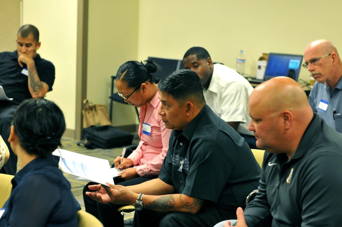 Army Reserve Sgt. Tommy Ruperto (center), program analyst, 63rd Regional Support Command, discusses methods to help someone displaying suicidal behavior during Applied Suicide Intervention Skills Training (ASIST), Aug. 24, Armed Forces Reserve Center, Mountain View, Calif. The two-day course, which uses a prescribed curriculum from Living Works Education, focuses primarily on intervention and how to safely assist those suffering from suicidal thoughts.