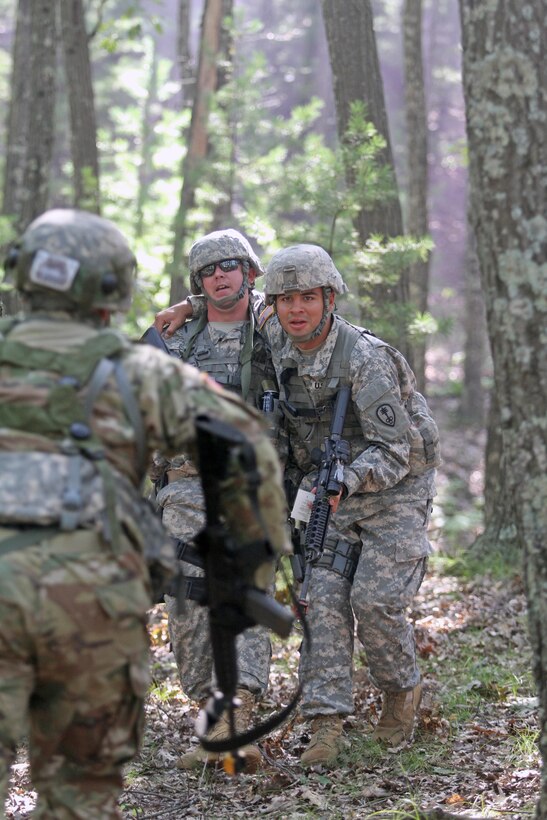 A U.S. Army Reserve Soldier assigned to the 303rd Military Police Company, 785th Military Police Battalion, 300th Military Police Brigade, 200th Military Police Command carries a fellow "injured" Soldier down a hill as another Reservist heads up the hill during a complex attack during Combat Support Training Exercise 86-16-03 (CSTX 86-16-03) on Fort McCoy, Wis., Aug. 22, 2016. Nearly 9,000 service members from across the country are participating in CSTX 86-16-03 hosted by the 86th Training Division and the 84th Training Command’s third and final CSTX of the year. (U.S. Army Reserve Photo by Sgt. 1st Class Clinton Wood).