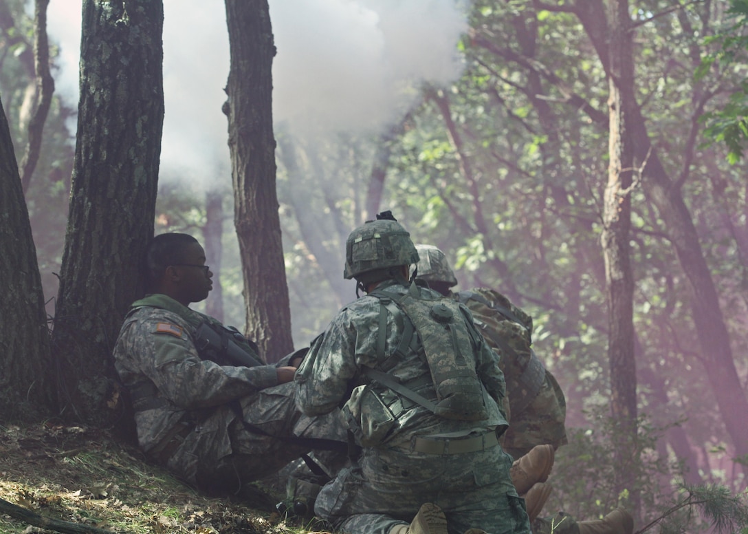 Two U.S. Army Reserve Soldiers rush to the aid of an "injured" Soldier as a simulated mortar goes off in a complex attack during Combat Support Training Exercise 86-16-03 (CSTX 86-16-03) on Fort McCoy, Wis., Aug. 22, 2016. Nearly 9,000 service members from across the country are participating in CSTX 86-16-03 hosted by the 86th Training Division and the 84th Training Command’s third and final CSTX of the year. (U.S. Army Reserve Photo by Sgt. 1st Class Clinton Wood).