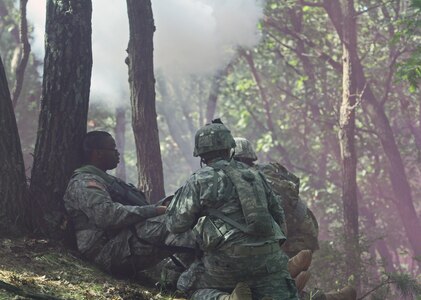 Two U.S. Army Reserve Soldiers rush to the aid of an "injured" Soldier as a simulated mortar goes off in a complex attack during Combat Support Training Exercise 86-16-03 (CSTX 86-16-03) on Fort McCoy, Wis., Aug. 22, 2016. Nearly 9,000 service members from across the country are participating in CSTX 86-16-03 hosted by the 86th Training Division and the 84th Training Command’s third and final CSTX of the year. (U.S. Army Reserve Photo by Sgt. 1st Class Clinton Wood).