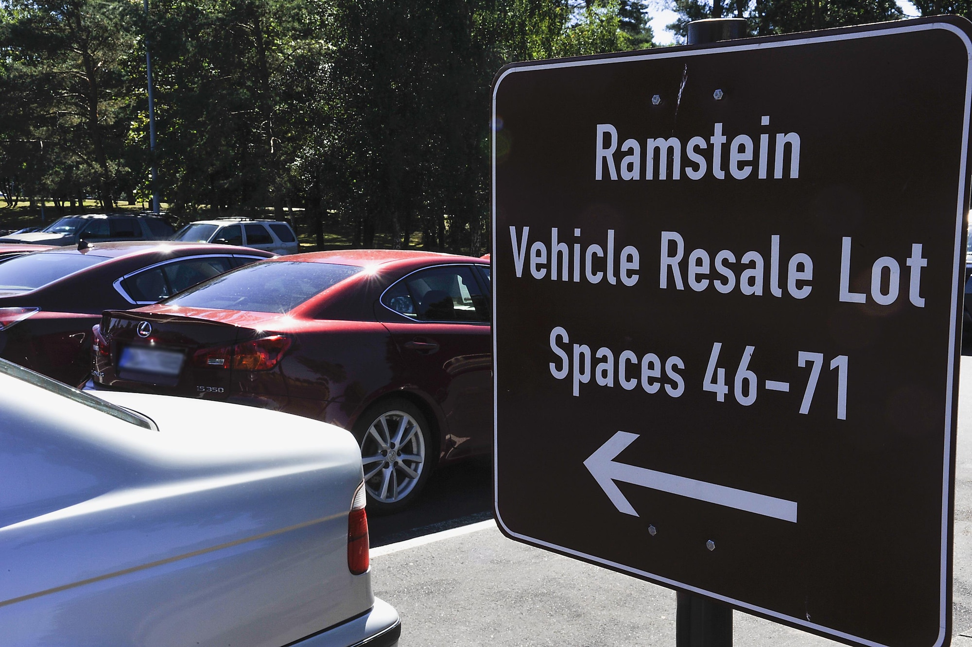 A sign points to parking spots at the 86th Force Support Squadron Outdoor Recreation resale lot Aug. 24, 2016, at Ramstein Air Base, Germany. The resale lot is located in the Northside Chapel parking lot, next to the Passenger Terminal long-term parking. (U.S. Air Force photo/Senior Airman Larissa Greatwood)