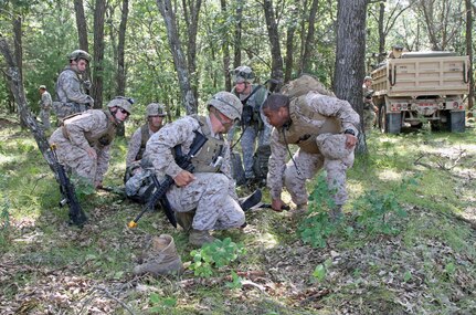 U.S. Marine Corps Reservist from Headquarters and Service Company, 4th Medical Battalion prepare to lift an "injured U.S. Army Reserve soldier after a complex attack during Combat Support Training Exercise 86-16-03 (CSTX 86-16-03) on Fort McCoy, Wis., Aug. 22, 2016. Nearly 9,000 service members from across the country are participating in CSTX 86-16-03 hosted by the 86th Training Division and the 84th Training Command’s third and final CSTX of the year. (U.S. Army Reserve Photo by Sgt. 1st Class Clinton Wood).