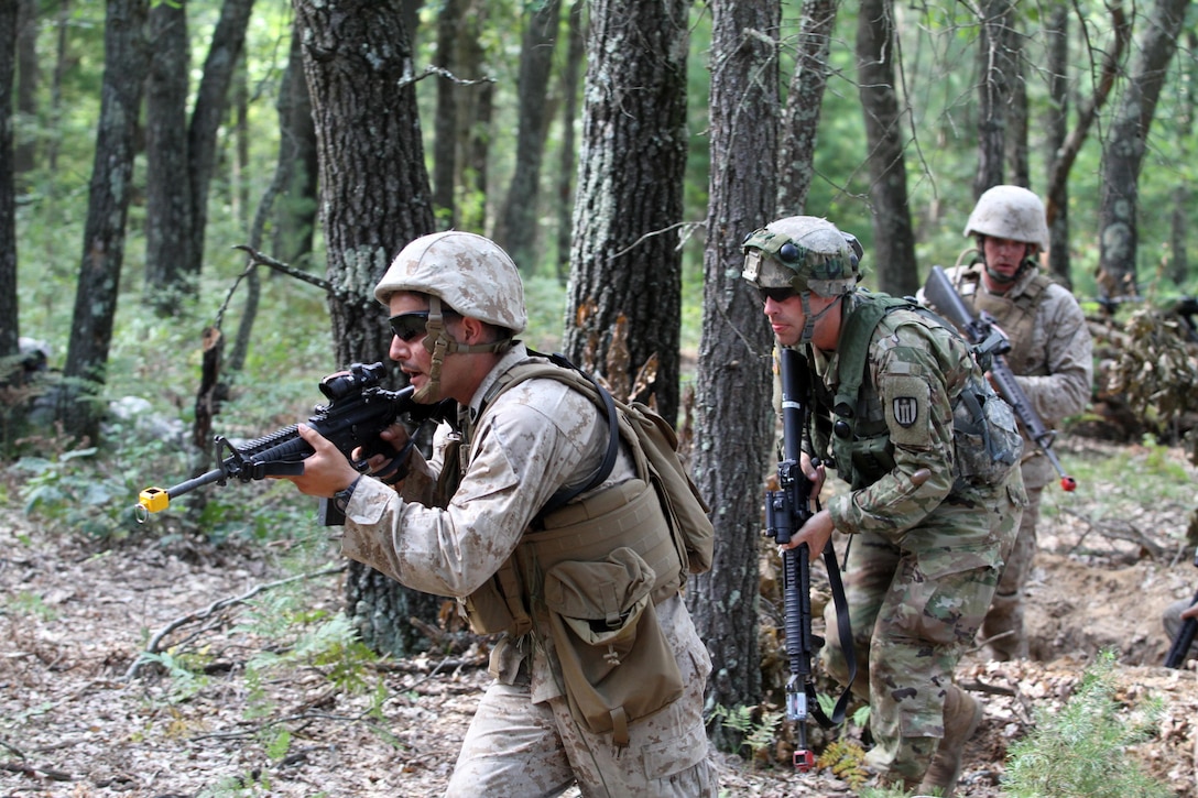 U.S. Marine Reservist Sgt. Arturo Garibay, Headquarters and Service Company, 4th Medical Battalion, leads a U.S. Army Reserve Soldier assigned to the 327th Engineer Company, 397th Engineer Battalion, 372nd Engineer Brigade, 416th Theater Support Command, and a fellow Marine up the hill in a complex attack during Combat Support Training Exercise 86-16-03 (CSTX 86-16-03) on Fort McCoy, Wis., Aug. 22, 2016. Nearly 9,000 service members from across the country are participating in CSTX 86-16-03 hosted by the 86th Training Division and the 84th Training Command’s third and final CSTX of the year. (U.S. Army Reserve Photo by Sgt. 1st Class Clinton Wood).