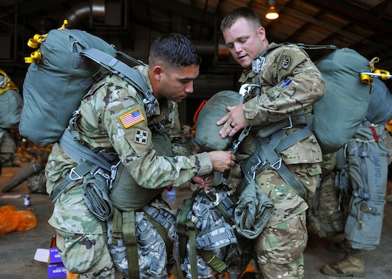 U.S Army soldiers secure their parachutes prior to a static-line jump in support of Exercise Green Flag Little Rock 16-09 Aug. 18, 2016, near Fort Polk, La. During the exercise, approximately 740 paratroopers were airdropped to include U.S. Air Force and U.S. Army personnel. (U.S. Air Force photo by Airman Kevin Sommer Giron)