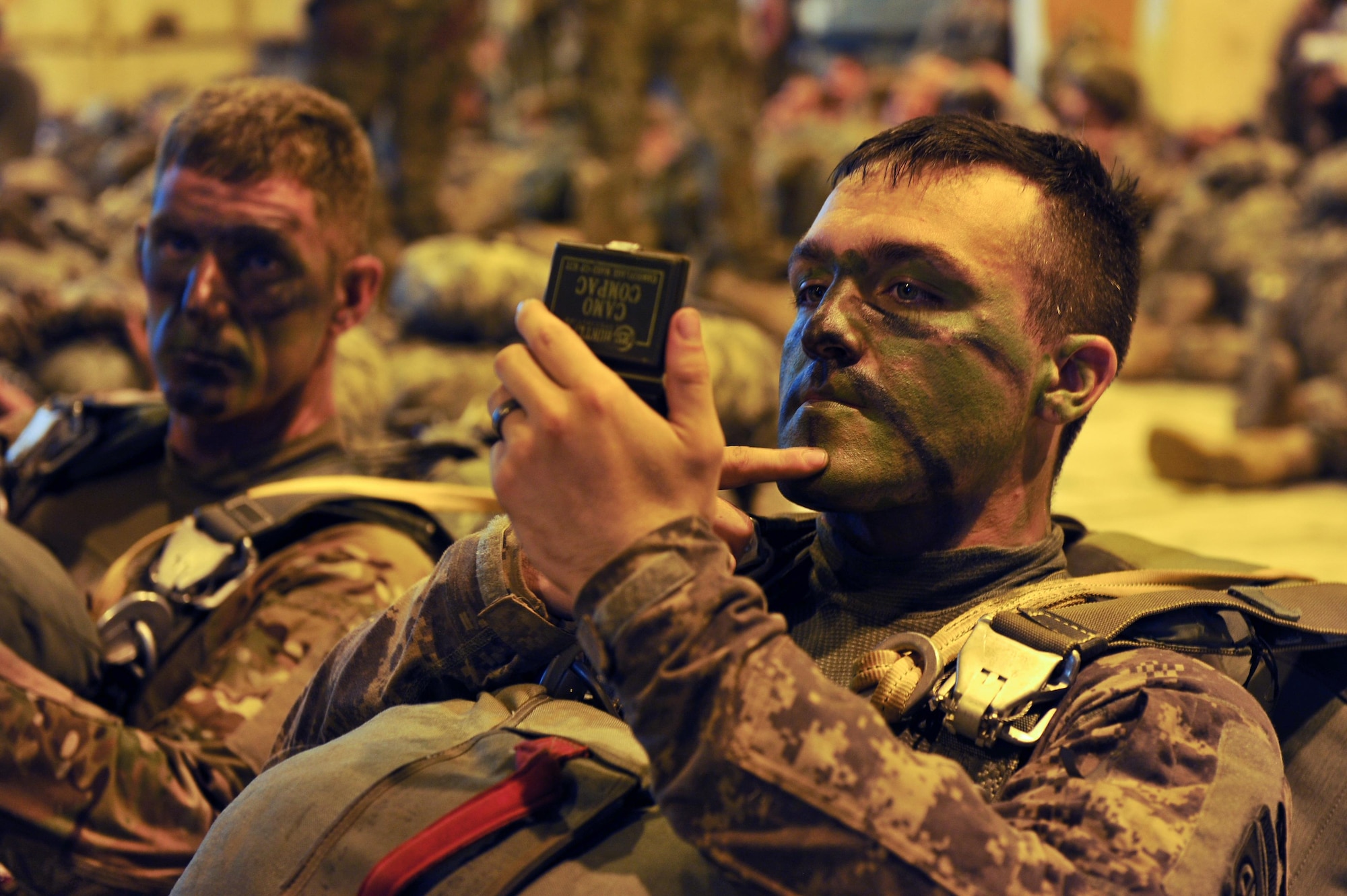 U.S. Army soldiers assigned to the 3rd Brigade Combat Team, 82nd Airborne Division from Fort Bragg, N.C., apply camouflage face paint in preparation for a static-line jump in support of Exercise Green Flag Little Rock 16-09 Aug. 18, 2016, near Fort Polk, La. Camouflage face paint is used to protect personnel from observation by enemy forces in a forest environment. (U.S. Air Force photo by Airman Kevin Sommer Giron)