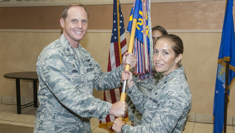 Lt. Col. Nicole Capozzi accepts the 682d Air Support Operations Squadron guidon from Col. Chris Jensen, 18th Air Support Operations Group commander, during a change-of-command ceremony at the group here July 22. Capozzi took command of the 682d ASOS from Lt. Col. David Arriola, who had commanded the unit since July 2014. (U.S. Air Force photo/Marc Barnes) 