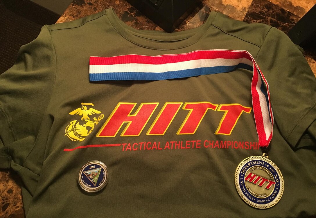 2nd Lt. Delaney T. Bourlakov, adjutant, Marine Corps Logistics Base Albany, receives a T-shirt and a medal for completing the second annual High Intensity Tactical Training Athlete Championship aboard Marine Corps Air Station Miramar in San Diego, Calif., Aug. 19.