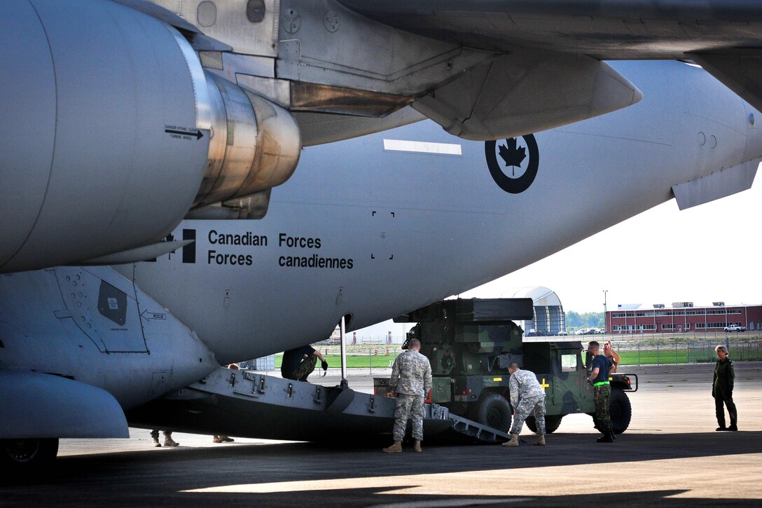 U.S. and Canadian soldiers load an Avenger air defense system onto a Canadian air force Globemaster III aircraft in Greenville, S.C., Aug. 13, 2016. Army National Guard photo by Staff Sgt. Roby Di Giovine
